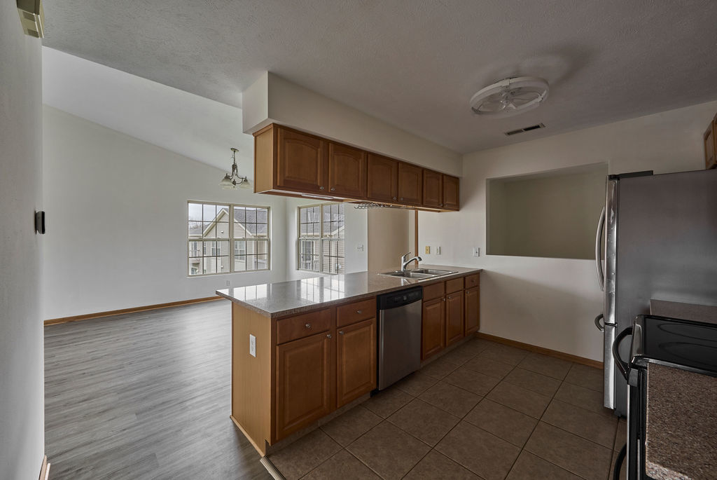 962 Arvle Circle, Unit 962 Sycamore, IL 60178 - Photo 7 of 18 a kitchen with stainless steel appliances a sink and a refrigerator