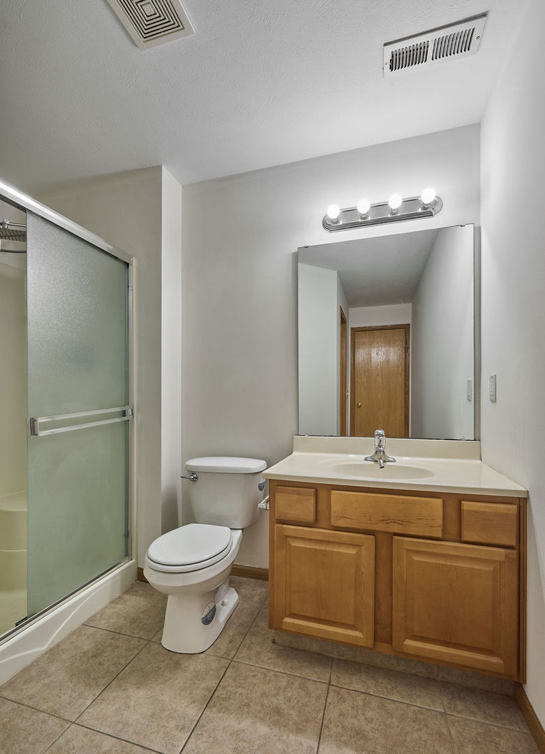 962 Arvle Circle, Unit 962 Sycamore, IL 60178 - Photo 9 of 18 a bathroom with a toilet sink and mirror