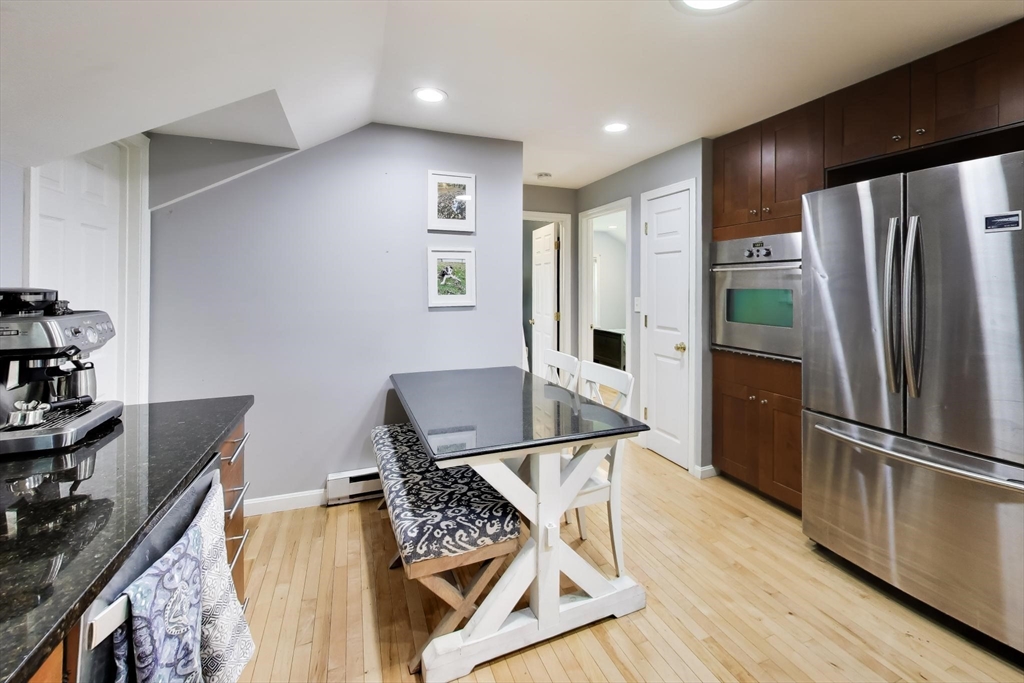 22 Douglas Road Ashland, MA 01721 - Photo 12 of 24 a view of a kitchen with an empty room and wooden floor