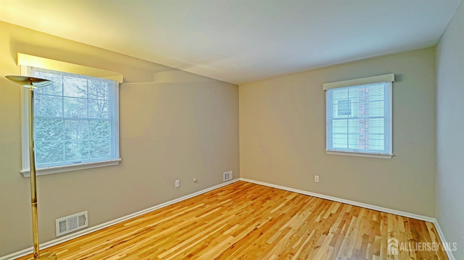 26 Lucille Court Edison, NJ 08820 - Photo 14 of 22 a view of empty room with wooden floor and fan