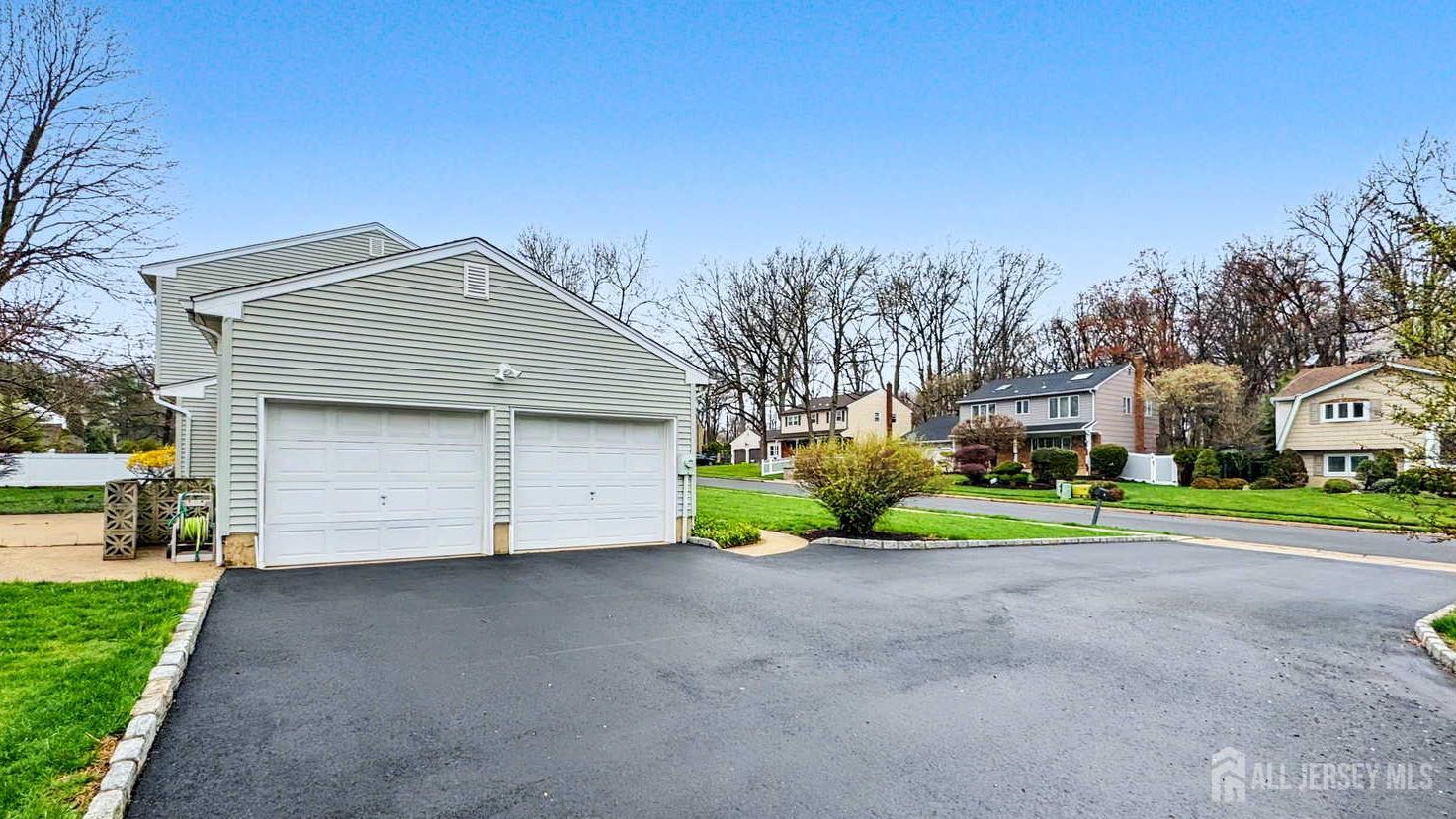 26 Lucille Court Edison, NJ 08820 - Photo 19 of 22 a front view of a house with a yard and garage