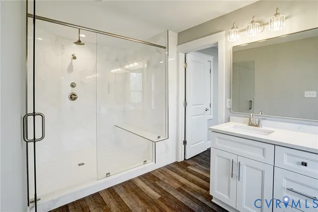 a bathroom with a double vanity sink mirror and shower
