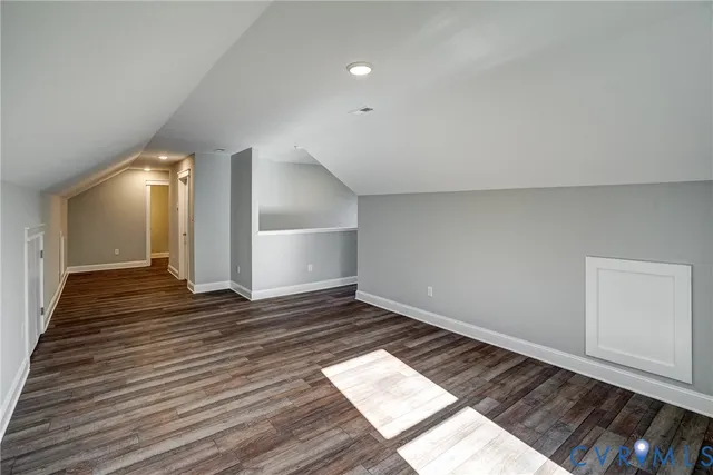 a view of an empty room and wooden floor