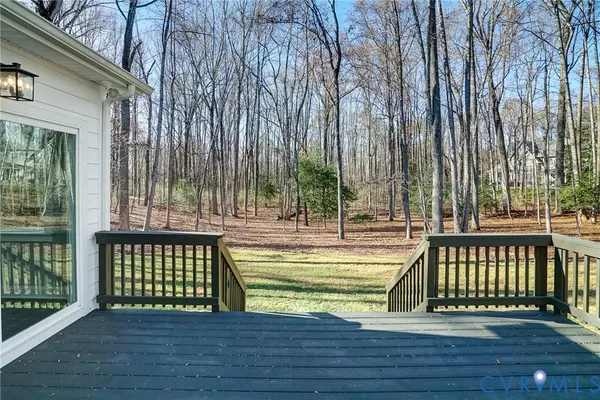 a view of a swimming pool with deck and a garden