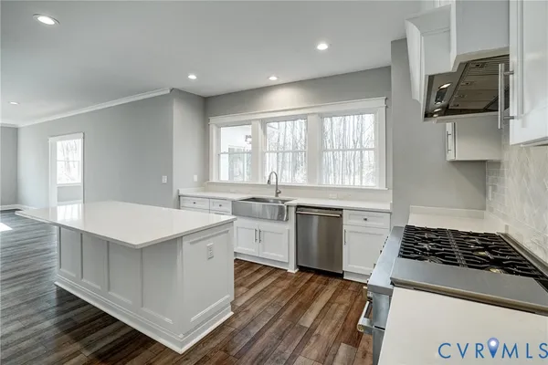 a kitchen with a stove a sink and a microwave