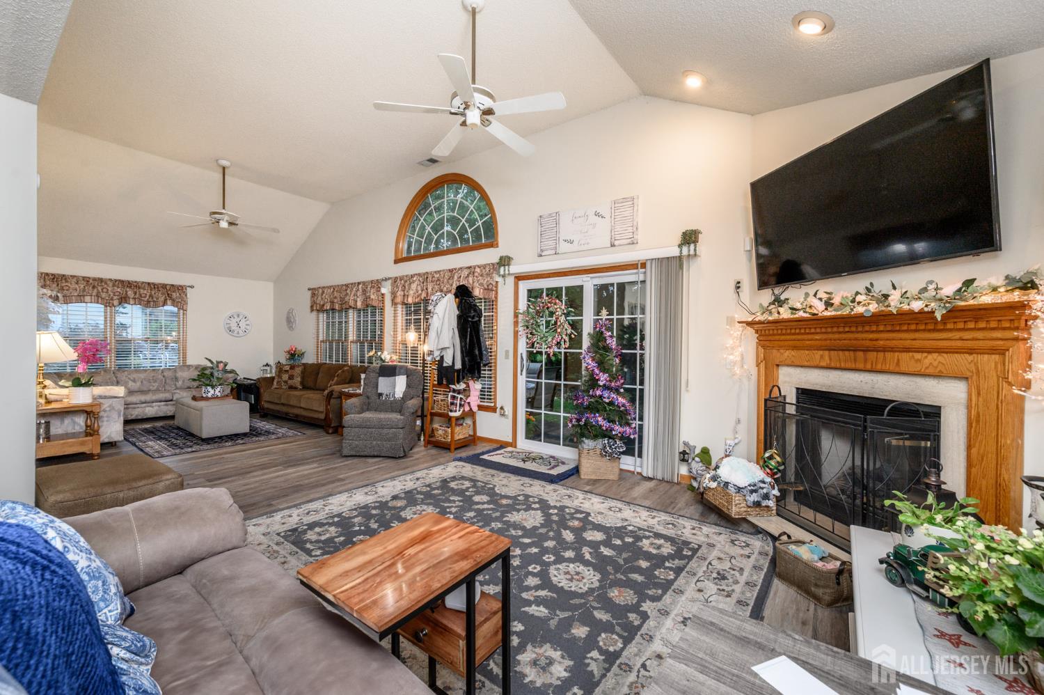 1617 Sweetbay Drive Toms River, NJ 08755 - Photo 18 of 32 a living room with furniture a flat screen tv and a fireplace
