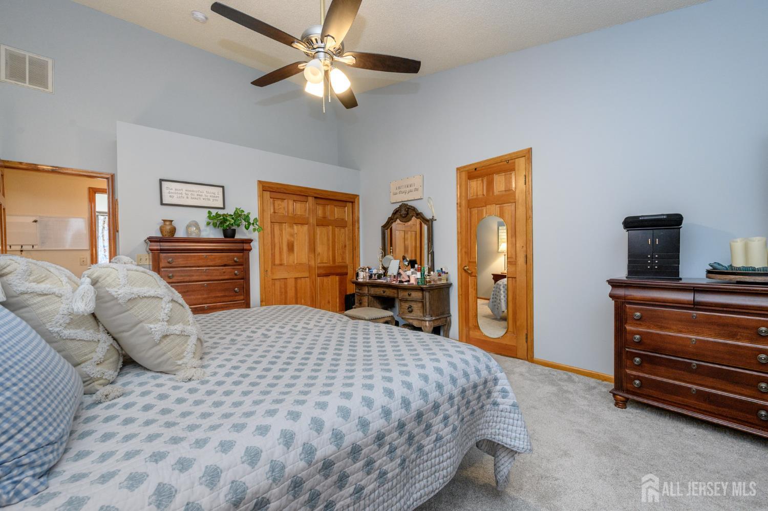 1617 Sweetbay Drive Toms River, NJ 08755 - Photo 24 of 32 a bedroom with a large bed and a chandelier