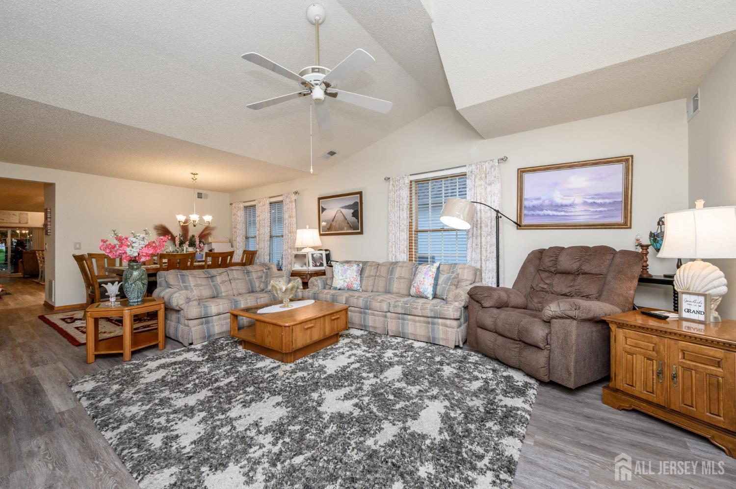 1617 Sweetbay Drive Toms River, NJ 08755 - Photo 6 of 32 a living room with furniture and a chandelier