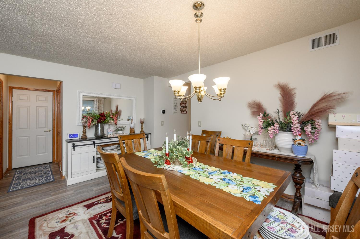 1617 Sweetbay Drive Toms River, NJ 08755 - Photo 9 of 32 a view of a dining room with furniture a rug and wooden floor
