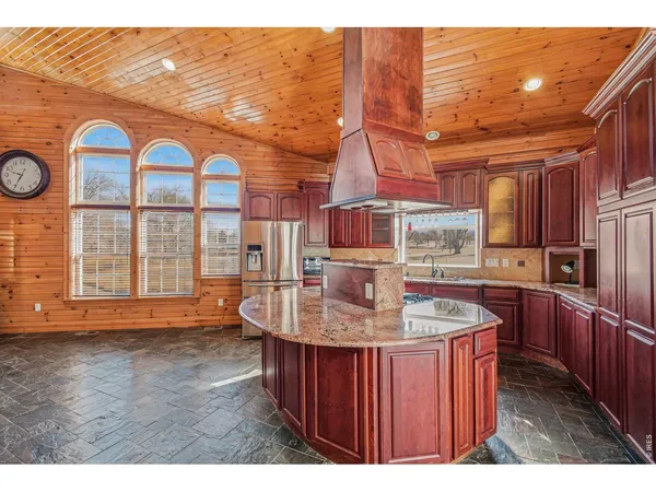 a kitchen with stainless steel appliances granite countertop a sink and cabinets