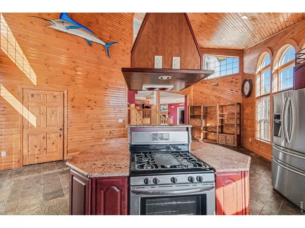 a kitchen with stainless steel appliances granite countertop a stove and a microwave