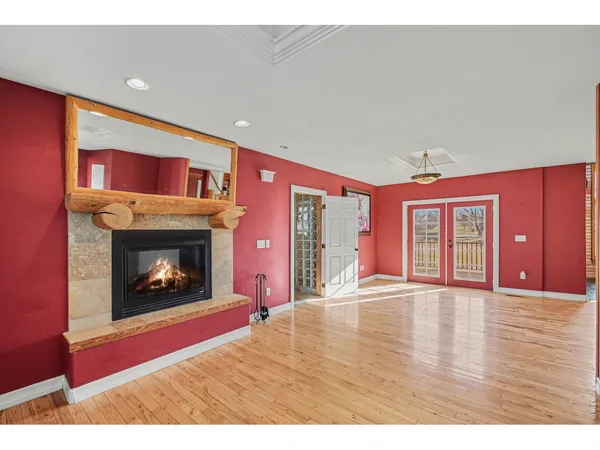 a view of an empty room with window and fire place