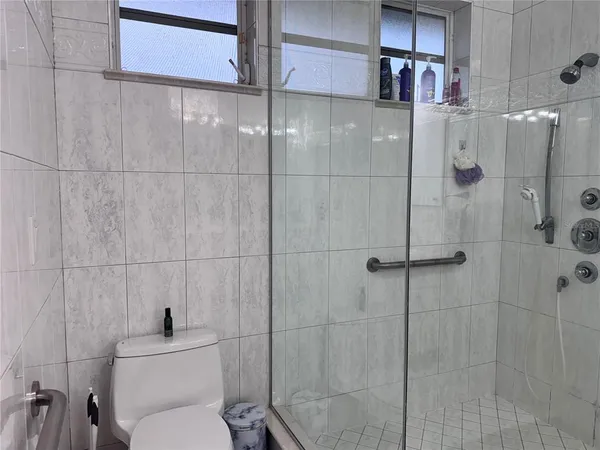 a bathroom with a toilet and shower