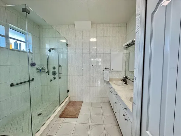 a bathroom with a granite countertop shower