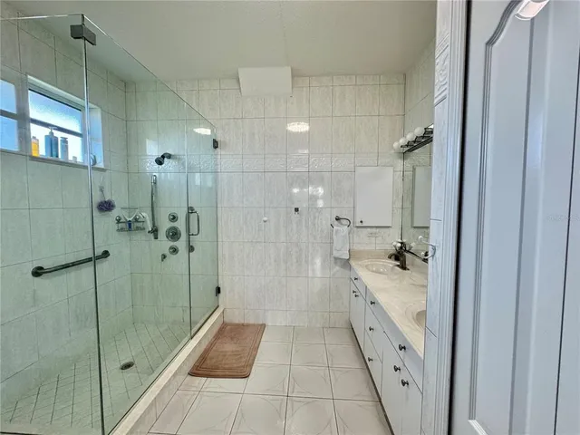 a bathroom with a granite countertop shower