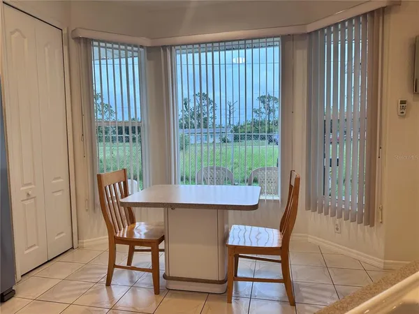 a view of a dining room with furniture window and outside view