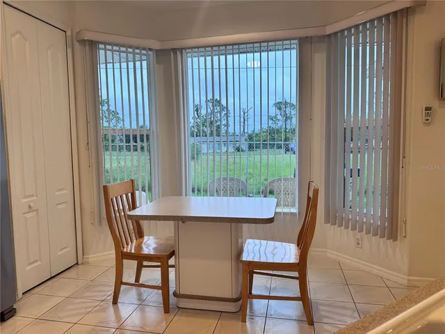 a view of a dining room with furniture window and outside view