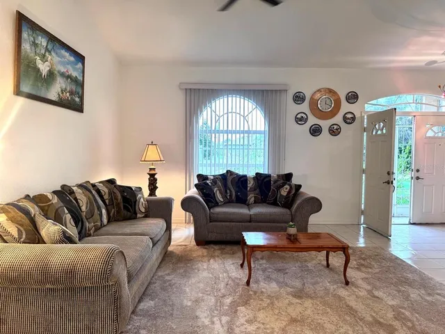 a living room with furniture and a large window