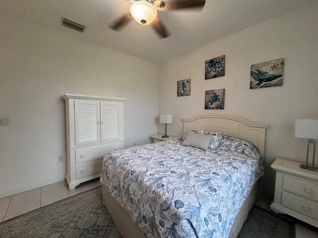 a bedroom with a large bed and a chandelier