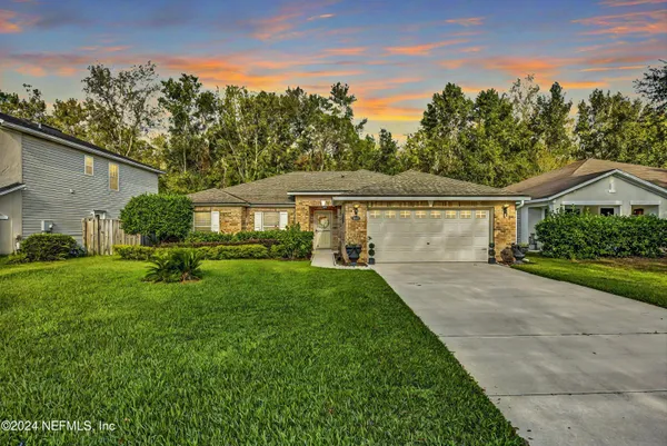a front view of house with yard and green space