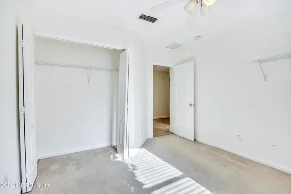 a view of a room with a ceiling fan