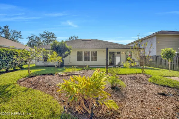 a view of a house with a backyard