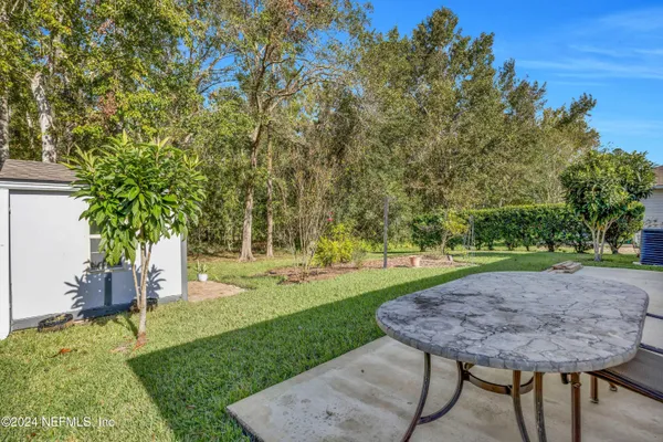 a view of a backyard with a garden and trees
