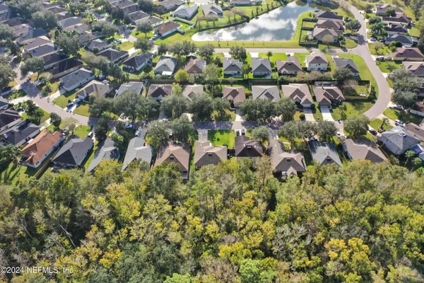 an aerial view of residential houses with outdoor space and covered with swimming pool