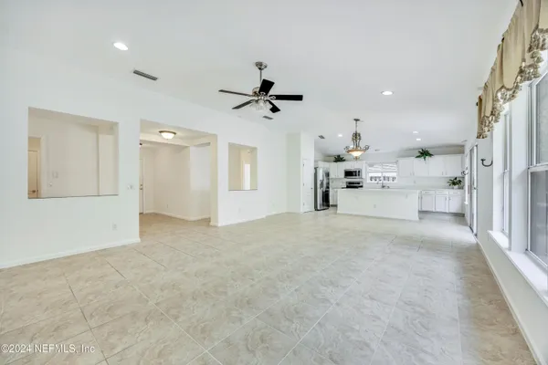 a view of a kitchen with a sink and a chandelier fan