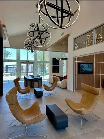 a living room with furniture a flat screen tv and a large window