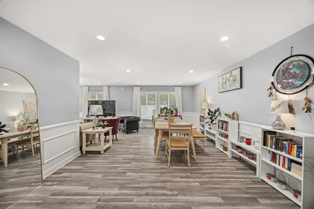 a living room with lots of furniture and kitchen view