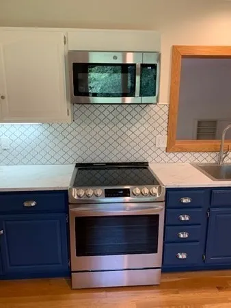 a kitchen with a stove and a microwave