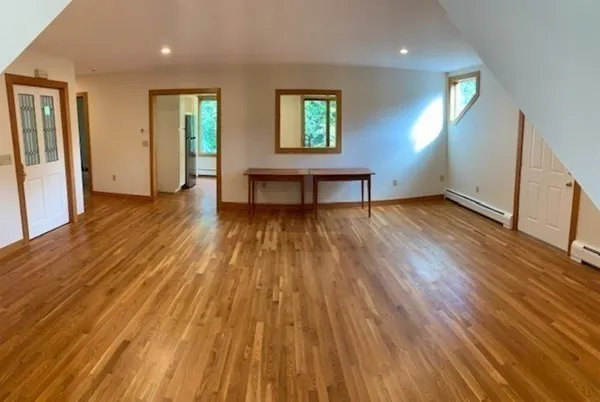 wooden floor in an empty room with a window