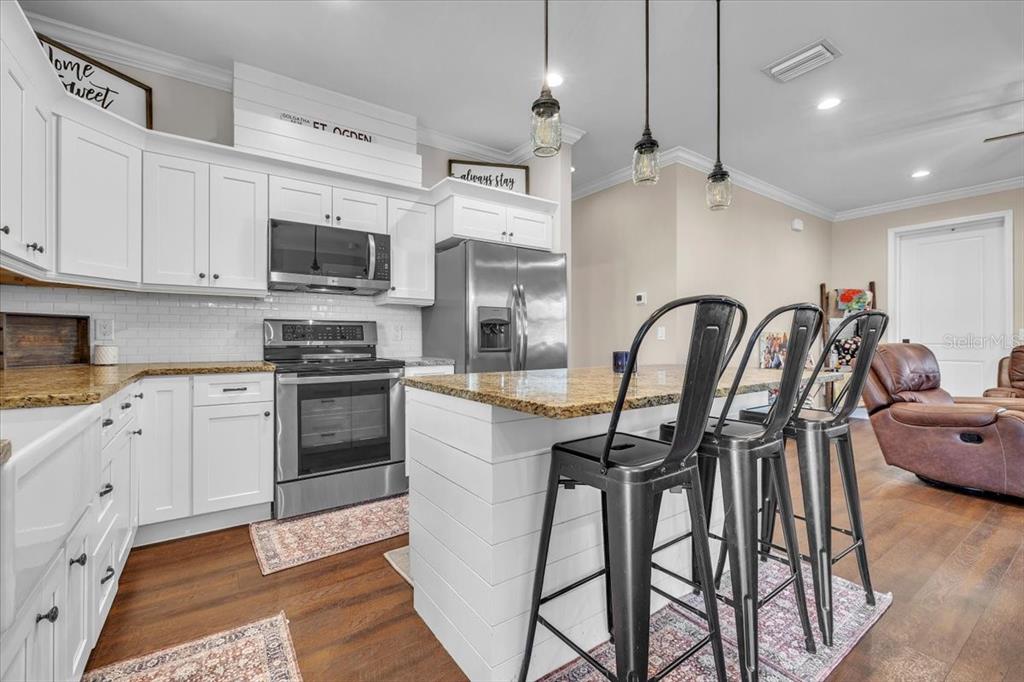 8429 Southwest Riverview Circle Arcadia, FL 34269 - Photo 11 of 45 a kitchen with stainless steel appliances granite countertop a stove a sink a refrigerator and a microwave