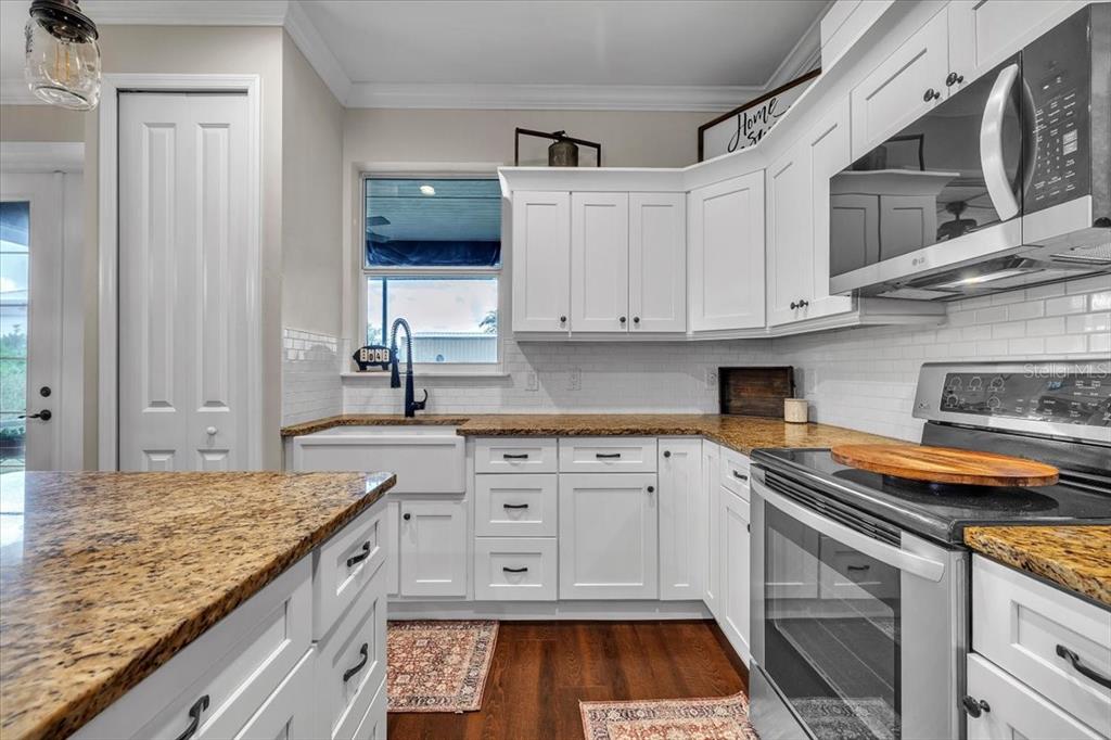 8429 Southwest Riverview Circle Arcadia, FL 34269 - Photo 12 of 45 a kitchen with granite countertop a sink and cabinets