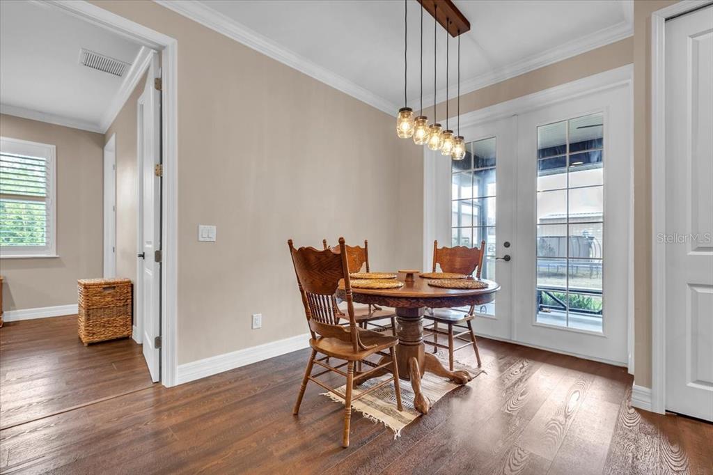 8429 Southwest Riverview Circle Arcadia, FL 34269 - Photo 13 of 45 a view of a dining room with furniture window and wooden floor