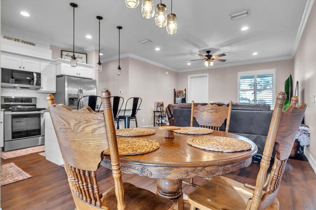 8429 Southwest Riverview Circle Arcadia, FL 34269 - Photo 16 of 45 a view of a dining room with furniture a kitchen and chandelier