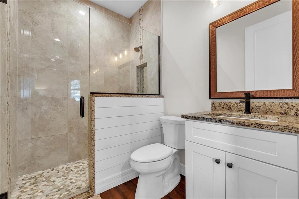 8429 Southwest Riverview Circle Arcadia, FL 34269 - Photo 19 of 45 a bathroom with a granite countertop sink a toilet and a mirror