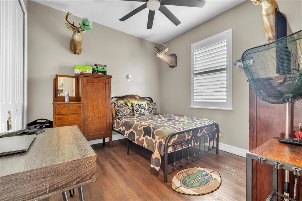 8429 Southwest Riverview Circle Arcadia, FL 34269 - Photo 20 of 45 a bedroom with a bed a window and dresser