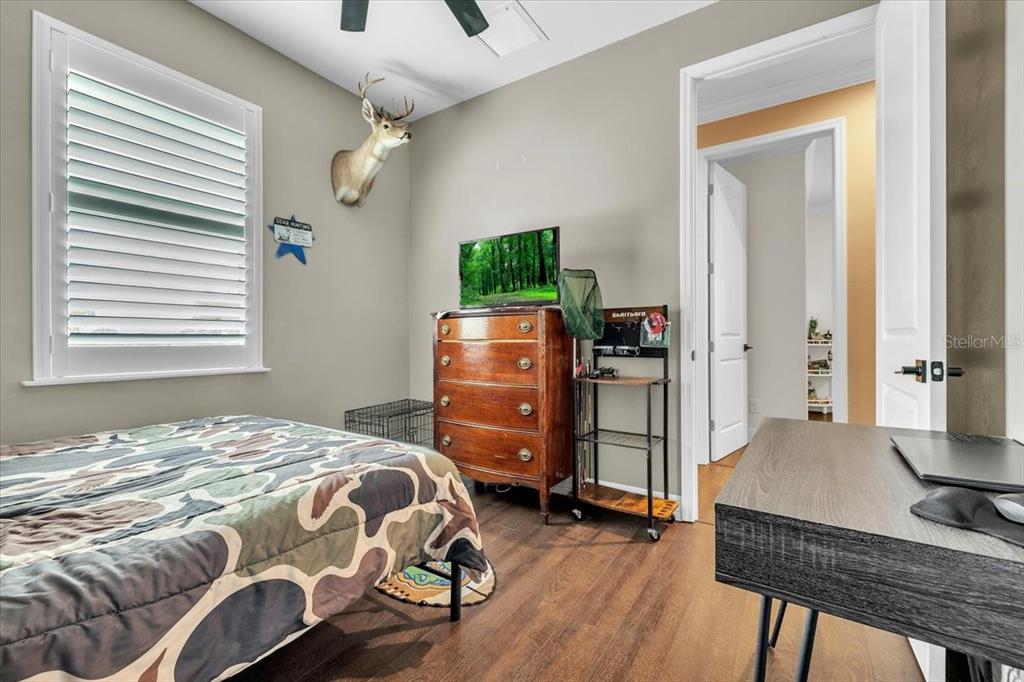 8429 Southwest Riverview Circle Arcadia, FL 34269 - Photo 21 of 45 a bedroom with a bed and wooden floor