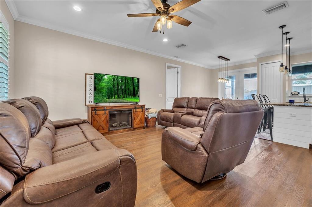8429 Southwest Riverview Circle Arcadia, FL 34269 - Photo 4 of 45 a living room with furniture a flat screen tv and a fireplace