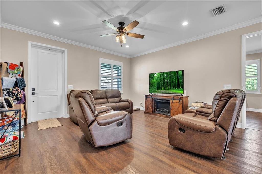 8429 Southwest Riverview Circle Arcadia, FL 34269 - Photo 5 of 45 a living room with furniture a window and a flat screen tv