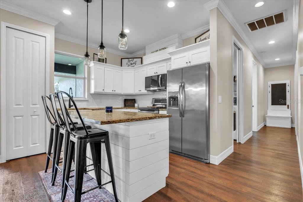 8429 Southwest Riverview Circle Arcadia, FL 34269 - Photo 6 of 45 a kitchen with stainless steel appliances granite countertop a kitchen island a stove a refrigerator and a view of living room