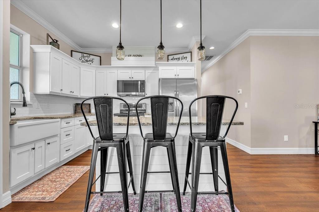 8429 Southwest Riverview Circle Arcadia, FL 34269 - Photo 7 of 45 a kitchen with stainless steel appliances granite countertop a table chairs sink and cabinets