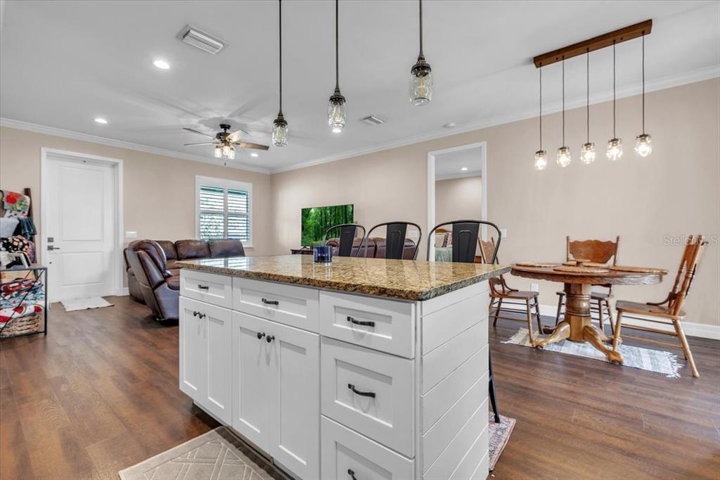 8429 Southwest Riverview Circle Arcadia, FL 34269 - Photo 10 of 45 a kitchen with stainless steel appliances granite countertop a kitchen island a stove a table and chairs in it
