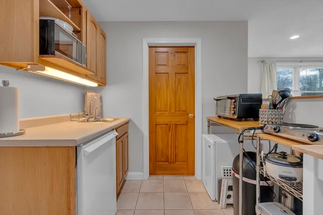 a kitchen with a refrigerator and a stove