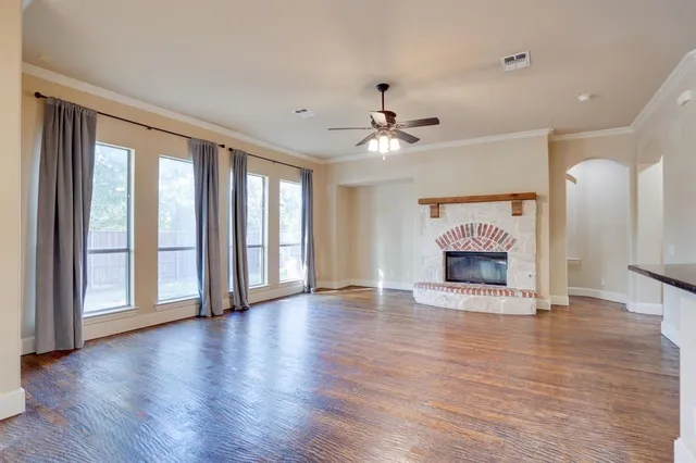 a living room with furniture a rug and a large window