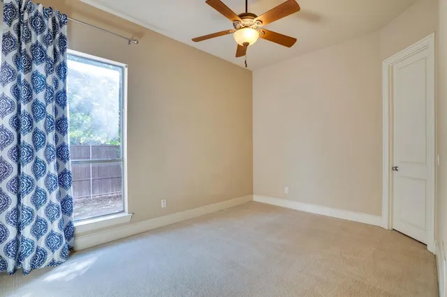 a bedroom with bed and a window