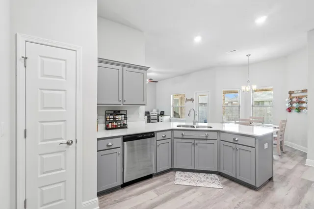 a kitchen with a sink stove and cabinets