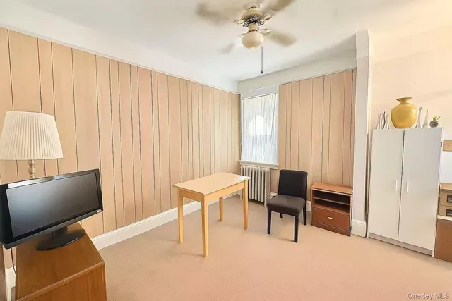 a view of a livingroom with furniture and a window